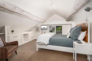a bedroom with a bed and a desk and a chair at Gray Owl Retreat in Big Sky