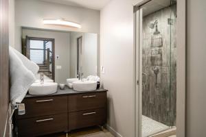 a bathroom with two sinks and a shower at Gray Owl Retreat in Big Sky +56 photos