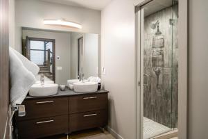 a bathroom with two sinks and a shower at Gray Owl Retreat in Big Sky