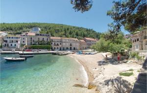 a beach in a town with boats in the water at 2 Bedroom Nice Apartment In Prigradica in Prigradica