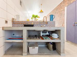 a kitchen with a counter with a sink in it at Dunes, Waves and Shells Self Catering Units and The Beach Shack Caravan Langebaan in Langebaan