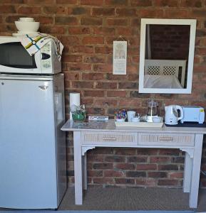 a white table with a microwave and a refrigerator at 712@Rest in Dullstroom