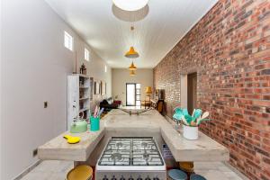 a kitchen with a brick wall and a stove at Dunes, Waves and Shells Self Catering Units and The Beach Shack Caravan Langebaan in Langebaan +70 photos