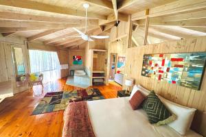 a living room with a white couch and wooden walls at Grampians Chalets in Halls Gap