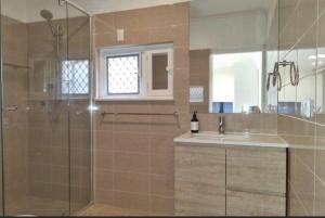a bathroom with a shower and a sink at Close to CBD Renovated Cottage in Prospect +6 photos