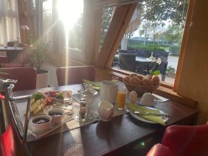 a table with a tray of breakfast food on it at Gasthaus Am Colphus in Barby