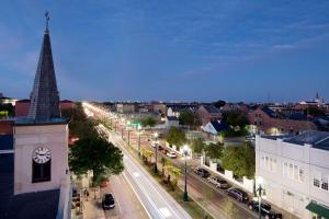 a city with a clock tower and a street with cars at Homewood Suites By Hilton New Orleans French Quarter in New Orleans