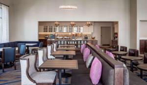 a restaurant with tables and chairs and a bar at Homewood Suites By Hilton New Orleans French Quarter in New Orleans