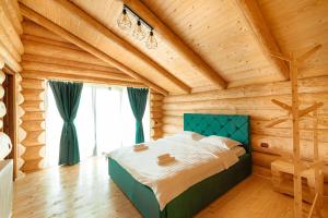 a bedroom with a bed in a wooden room at Fox Wood House in Ciobotani +27 photos
