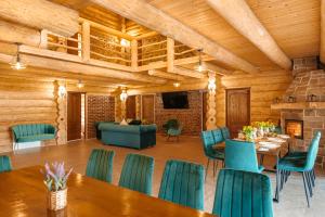 a dining room with wooden ceilings and blue chairs at Fox Wood House in Ciobotani