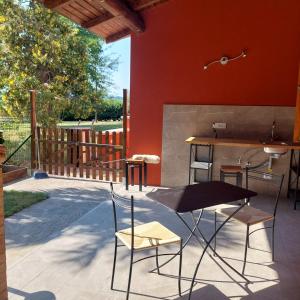 a patio with a table and chairs and a counter at Il Conte di Montechiaro Rural B&B in Sasso Marconi