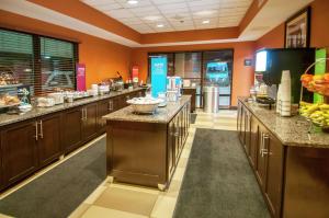 a large kitchen with brown cabinets and a cafeteria at Hampton Inn Metairie in Metairie