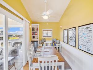 a dining room with a table and chairs at Celestial Dreams in Galveston +4 photos