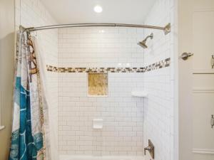 a bathroom with a shower with white subway tiles at Celestial Dreams in Galveston