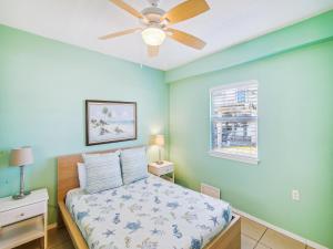 a bedroom with a bed and a ceiling fan at Celestial Dreams in Galveston