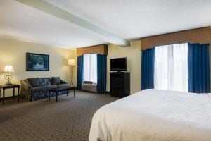 a hotel room with a bed and a couch at Hampton Inn Murrells Inlet/Myrtle Beach Area in Myrtle Beach