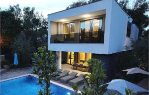 a house with a swimming pool in front of it at Villa Mara in Zaton