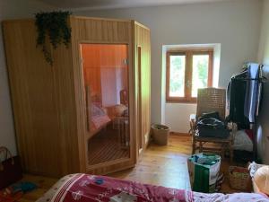 a room with a large wooden cabinet with a mirror at Maison en pierre dans le Sidobre in Le Bez