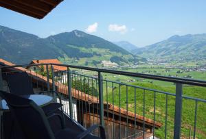 a balcony with chairs and a view of a valley at Ferienhaus Stockli in Brunnen