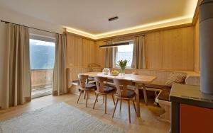 a dining room with a wooden table and chairs at Bergchalet Emberg mit Sauna in Aschau