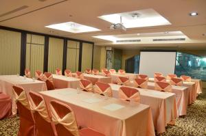 a conference room with white tables and orange chairs at Hotel Formosa in Caotun +49 photos
