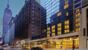 a large building with windows on a city street at Hilton Garden Inn New York/Midtown Park Avenue in New York