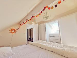 a bedroom with a white bed with christmas decorations at Izzy's Rainbow House in De Haan