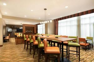 a conference room with a long table and chairs at Hampton Inn New York - LaGuardia Airport in Queens