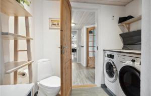 a small laundry room with a washer and dryer at Lovely Home In Haderslev With Wifi in Diernæs