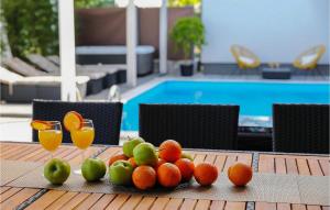 een fruitschaal op een tafel naast een zwembad bij Villa Nerina in Nin