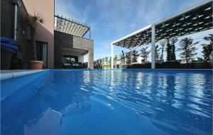 a large blue swimming pool next to a house at Villa Nerina in Nin