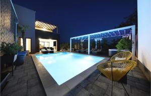 a swimming pool in the backyard of a house at night at Villa Nerina in Nin +26 photos