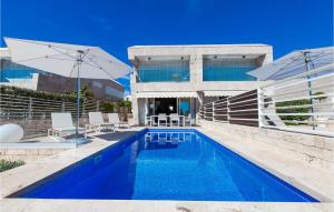 a swimming pool in front of a building at Villa Olea in Petrcane