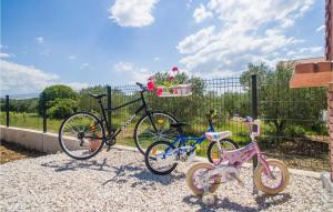 two bikes are parked next to a fence at Villa Oasis in Sukošan