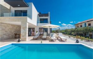 a villa with a swimming pool and a house at Villa Oasis in Sukošan