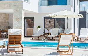 a patio with chairs and an umbrella next to a pool at Villa Oasis in Sukošan +22 photos