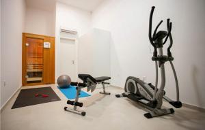 a gym with two exercise bikes and a exercise ball at Villa Crystal Blue in Rogoznica