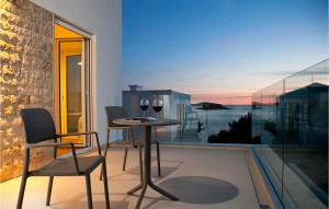 a balcony with a table and two glasses of wine at Villa Crystal Blue in Rogoznica