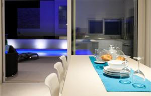 a dining room with a table with a plate of food at Villa Crystal Blue in Rogoznica +16 photos