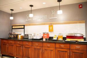 a restaurant kitchen with a counter with a counter top at Hampton Inn & Suites Jacksonville in Jacksonville