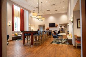 a lobby with a bar with chairs and a table at Hampton Inn & Suites Jacksonville in Jacksonville