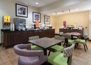 a restaurant with a table and chairs and a counter at Hampton Inn Odessa in Odessa