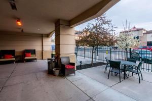 a patio with a table and chairs and a fence at Hilton Garden Inn Ogden in Ogden