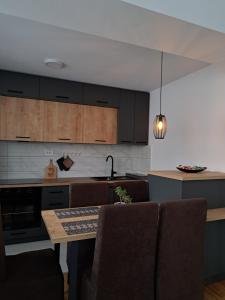 a kitchen with a table and some chairs and a counter at Urban Haven in Skopje
