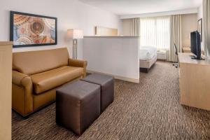 a hotel room with a couch and a television at DoubleTree by Hilton Olympia in Olympia