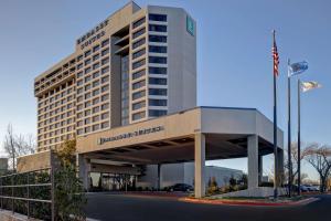 a large building with a sign for a hotel at Embassy Suites By Hilton Oklahoma City Northwest in Oklahoma City