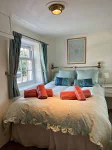 a bedroom with a large bed with two pillows on it at The Boathouse in Golant