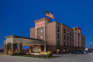 a hotel with an american flag on top of it at Hampton Inn Bellevue in Bellevue