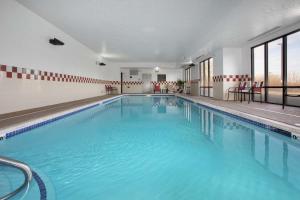 a large swimming pool with blue water in a building at Hampton Inn Bellevue in Bellevue