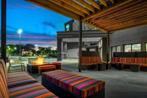 a patio with chairs and a fire pit in a building at Home2 Suites by Hilton Omaha I-80 at 72nd Street, NE in Omaha